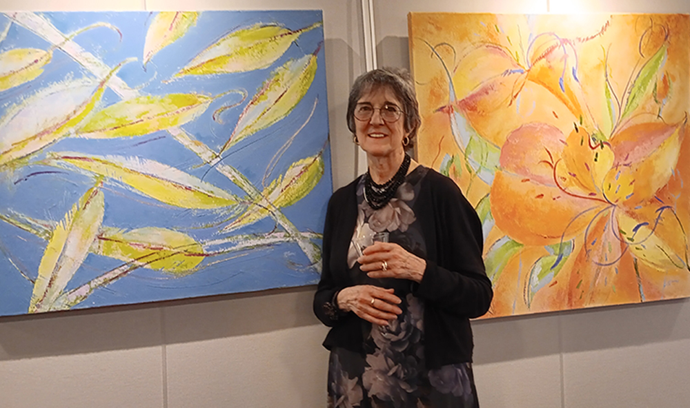 Artist with paintings in Field gallery